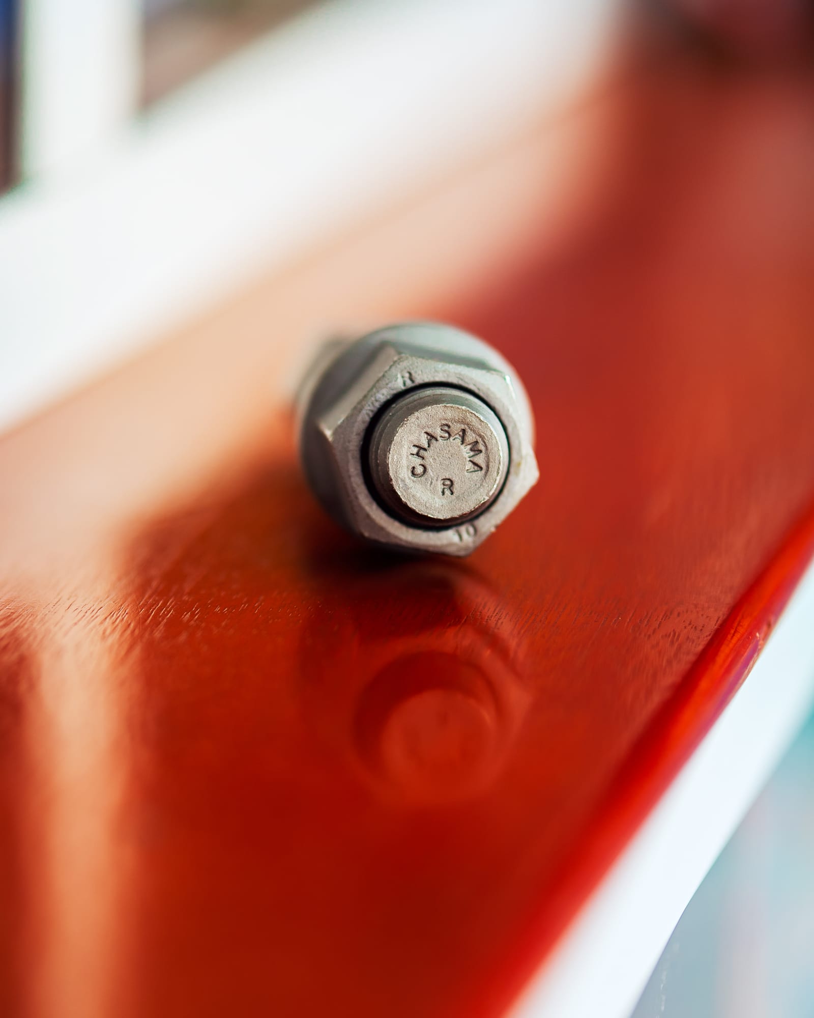 Hex bolt with nut, the bolt head stamped with the Chasama name